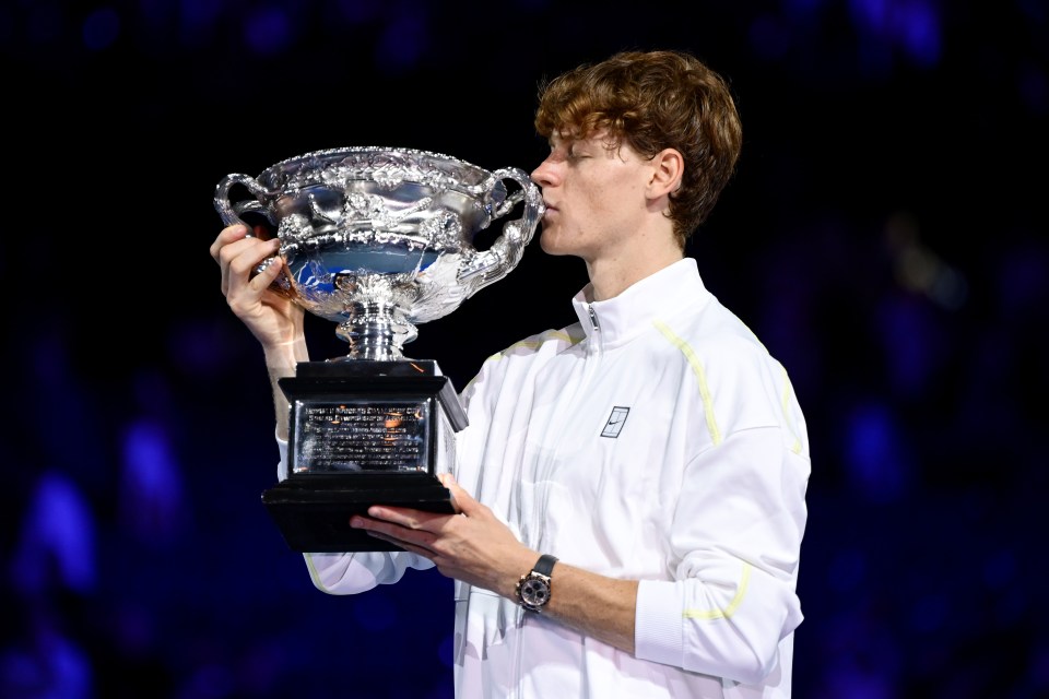 Jannik Sinner kissing the Norman Brookes Challenge Cup after winning the Australian Open.