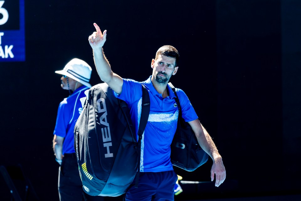 Novak Djokovic waves to the crowd after retiring from an Australian Open semifinal match.