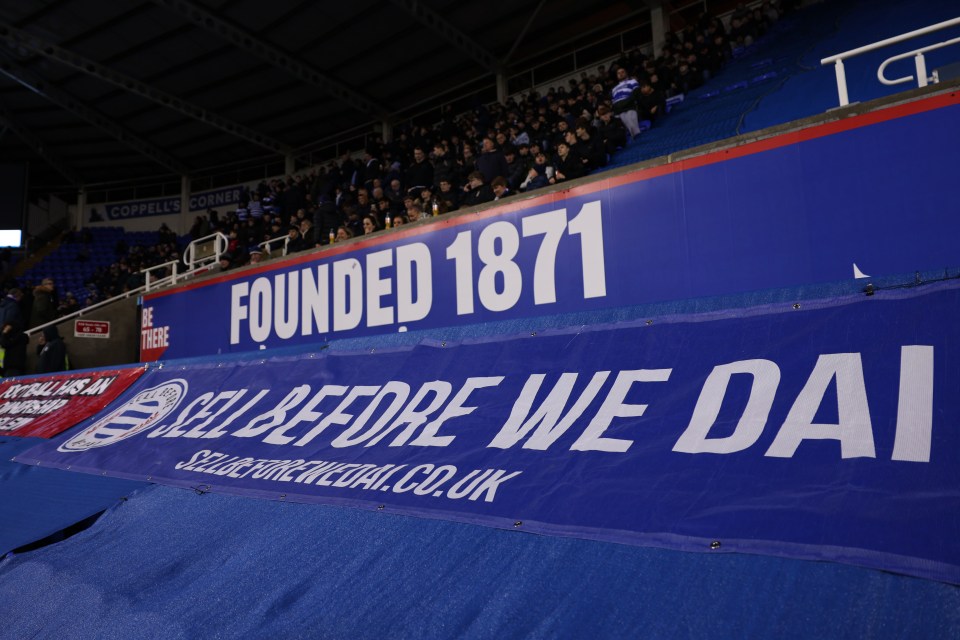 Reading fans protest against club owner with banner reading "Sell Before We Dai".