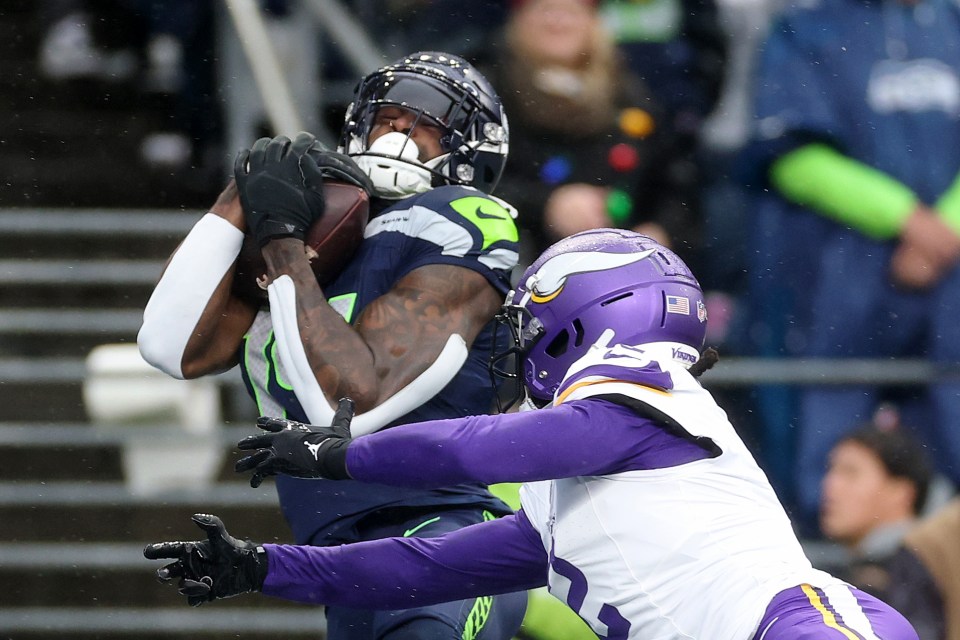 SEATTLE, WASHINGTON - DECEMBER 22: DK Metcalf #14 of the Seattle Seahawks catches a touchdown against Stephon Gilmore #2 of the Minnesota Vikings at Lumen Field on December 22, 2024 in Seattle, Washington. (Photo by Steph Chambers/Getty Images)