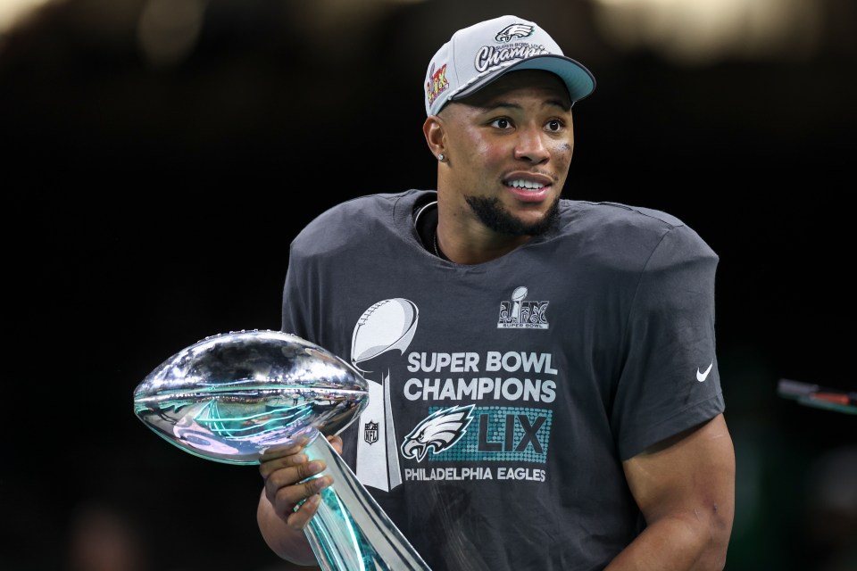 NEW ORLEANS, LOUISIANA - FEBRUARY 09: Saquon Barkley #26 of the Philadelphia Eagles holds the Vince Lombardi Trophy after winning Super Bowl LIX against the Kansas City Chiefs at Caesars Superdome on February 09, 2025 in New Orleans, Louisiana. The Eagles defeated the Chiefs 40-22. (Kara Durrette/Getty Images)