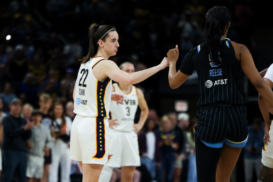The Indiana Fever's Caitlin Clark (22) fist-bumps the Chicago Sky's Angel Reese before a game at Wintrust Arena on June 23, 2024, in Chicago. (Eileen T. Meslar/Chicago Tribune/Tribune News Service via Getty Images)