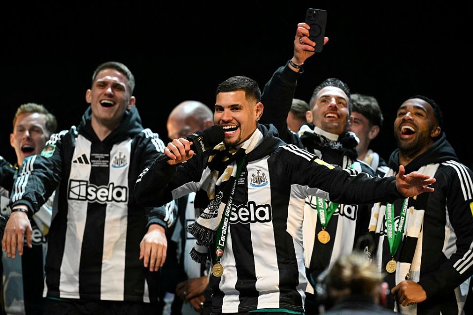 Newcastle United's Brazilian midfielder #39 Bruno Guimaraes celebrates with teammates on stage at the Town Moor in Newcastle upon Tyne, in north-east England, on March 29, 2025, during a celebration and presentation of the League Cup trophy with fans after Newcastle United won the English League Cup, their first domestic trophy for 70 years. (Photo by Oli SCARFF / AFP) (Photo by OLI SCARFF/AFP via Getty Images)