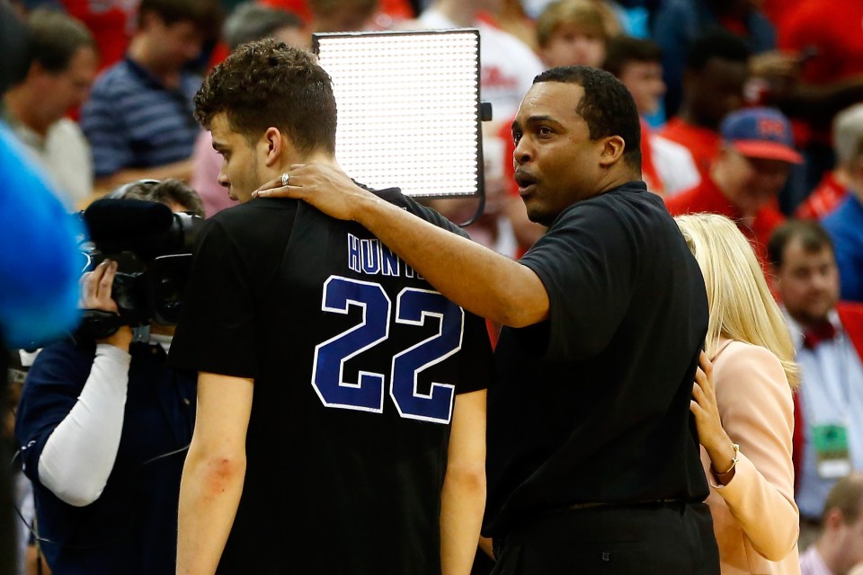 JACKSONVILLE, FL - MARCH 19:  Head coach Ron Hunter of the Georgia State Panthers puts his arm around son and player R.J. Hunter #22 after the Panthers 57-56 win against the Baylor Bears during the second round of the 2015 NCAA Men's Basketball Tournament at Jacksonville Veterans Memorial Arena on March 19, 2015 in Jacksonville, Florida.  (Photo by Kevin C. Cox/Getty Images)