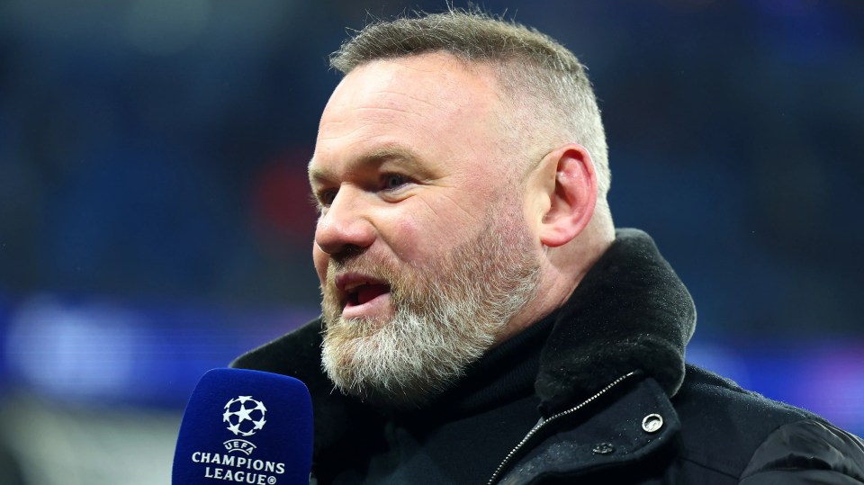 Wayne Rooney speaking into a Champions League microphone.
