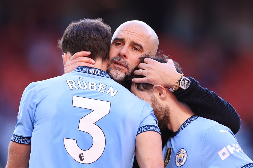 MANCHESTER, ENGLAND - APRIL 6: Manchester City manager Pep Guardiola hugs Ruben Dias of Manchester City (L) and Bernardo Silva of Manchester City after the Premier League match between Manchester United FC and Manchester City FC at Old Trafford on April 6, 2025 in Manchester, England. (Photo by Simon Stacpoole/Offside/Offside via Getty Images)