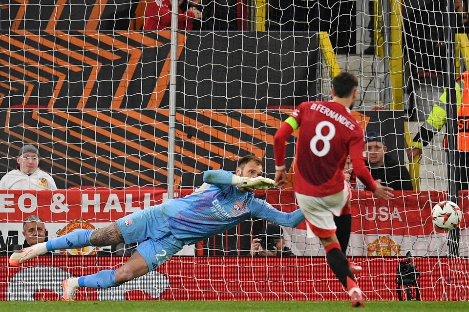 Manchester United's Portuguese midfielder #08 Bruno Fernandes scores their third goal past Lyon's Brazilian goalkeeper #23 Lucas Perri (L) from the penalty spot during the UEFA Europa league quarter-final final, second leg football match between Manchester United and Lyon at Old Trafford stadium in Manchester, north west England, on April 17, 2025. (Photo by Oli SCARFF / AFP) (Photo by OLI SCARFF/AFP via Getty Images)