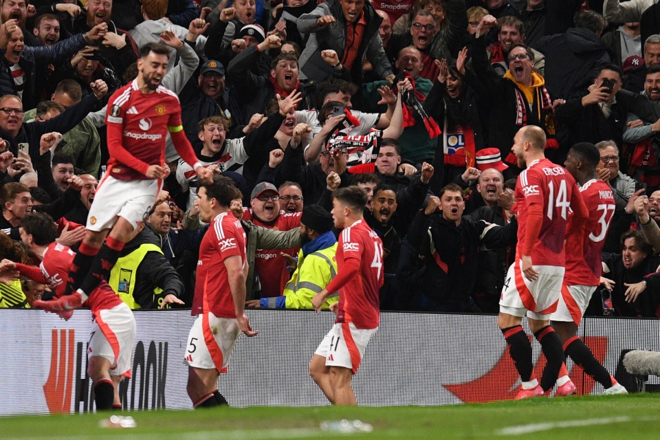 Manchester United's English defender #05 Harry Maguire (2L) and teammates celebrate with their fans after Maguire scores their fifth goal during the UEFA Europa league quarter-final final, second leg football match between Manchester United and Lyon at Old Trafford stadium in Manchester, north west England, on April 17, 2025. (Photo by Oli SCARFF / AFP) (Photo by OLI SCARFF/AFP via Getty Images)