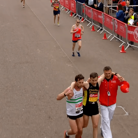 A race official joined the pair to help them over the line as the crowd cheered