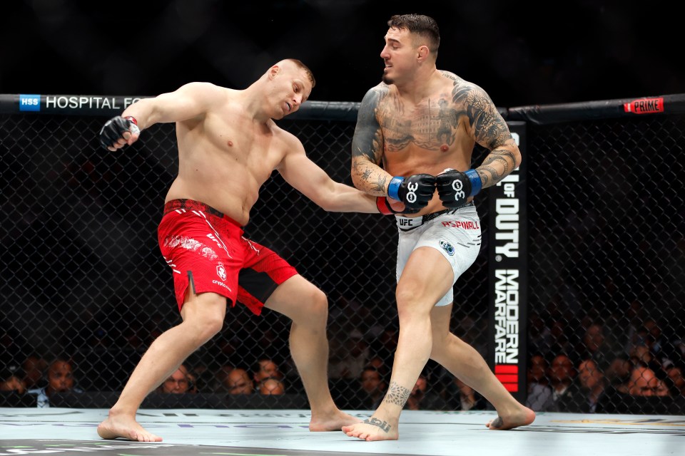 NEW YORK, NEW YORK - NOVEMBER 11: (R-L) Tom Aspinall of England knocks out Sergei Pavlovich of Russia in the interim UFC heavyweight championship fight during the UFC 295 event at Madison Square Garden on November 11, 2023 in New York City. (Photo by Sarah Stier/Getty Images)