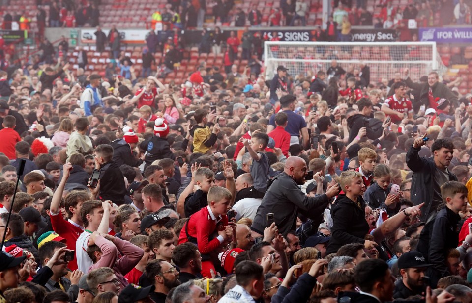 Fans flooded onto the pitch at full-time as they celebrated their latest success